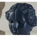 Navy blue split classical female goddess face close-up showing distinct hairline seam detail