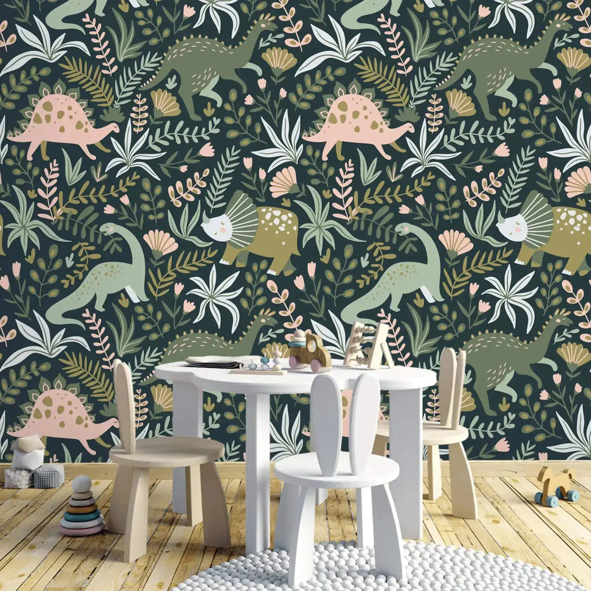 Dino Garden Oasis wallpaper behind white children's round table and chairs in playroom with wooden floor.