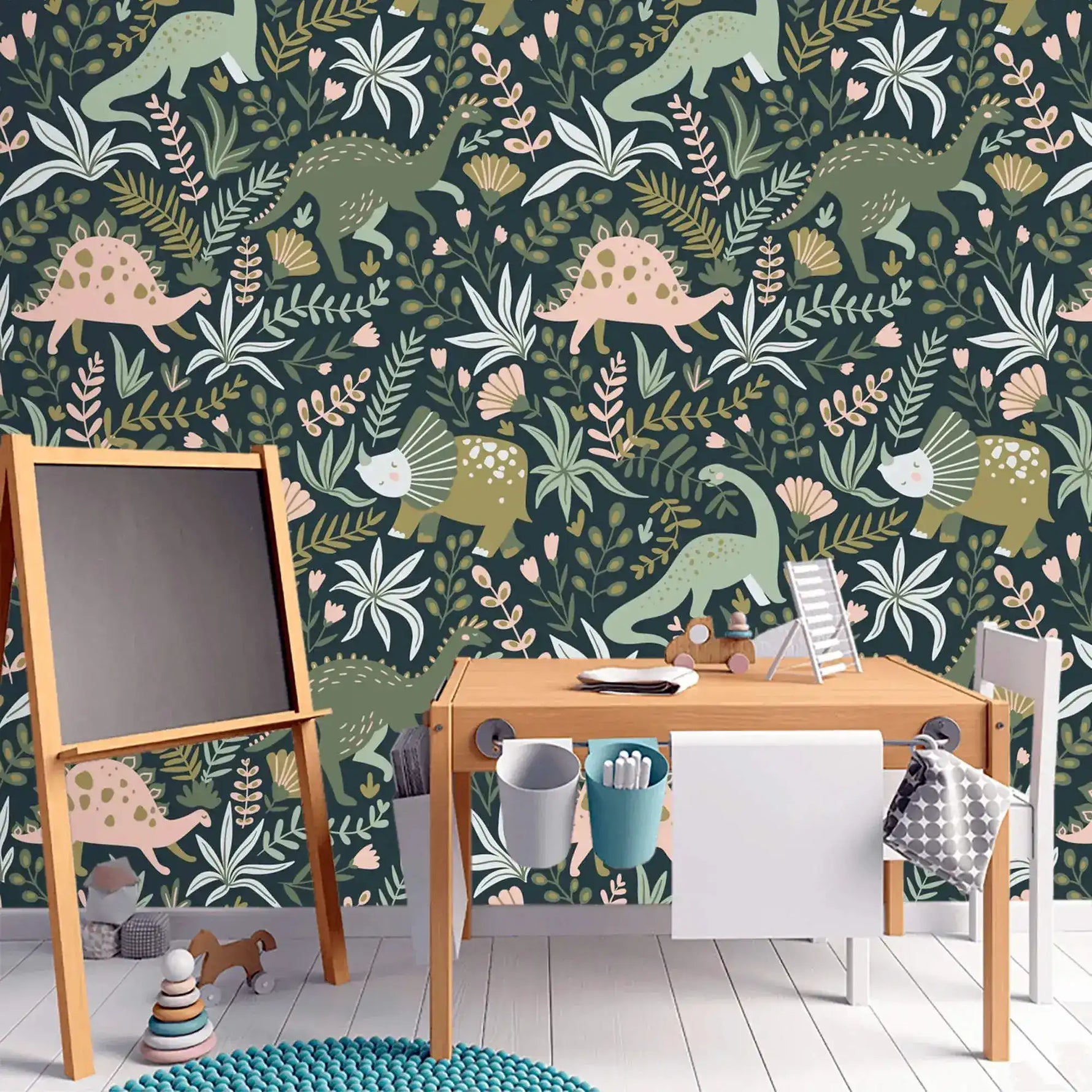 Dino Garden Oasis wallpaper in kids study with wooden easel chalkboard, art desk, chair, and teal knit rug.