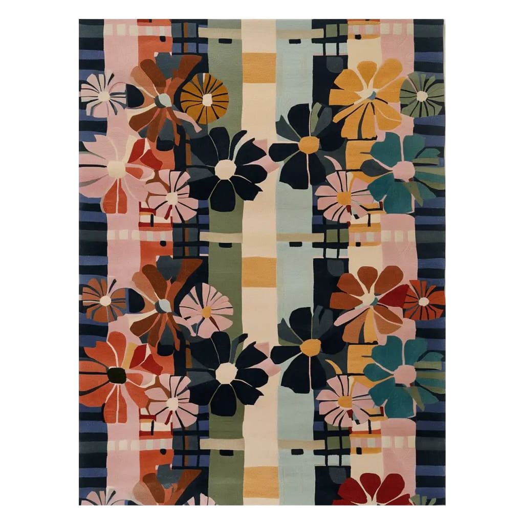 A vibrant hand-tufted wool area rug featuring a colorful floral pattern with bold daisies in shades of pink, orange, blue, and green. The design includes geometric accents, creating a lively and artistic look, perfect for adding a splash of color to any room.