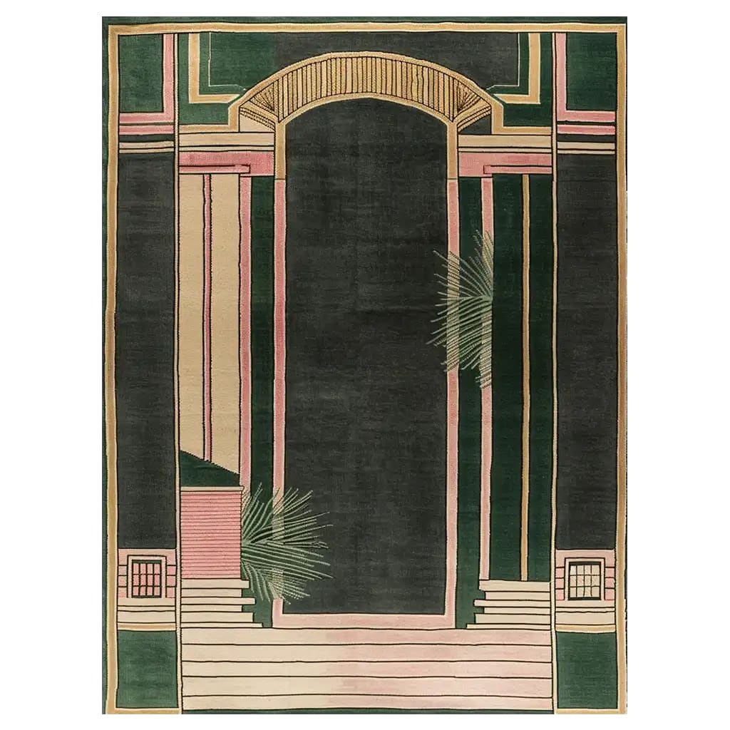 A beautifully designed hand-tufted wool area rug featuring an intricate geometric pattern in shades of green, pink, and beige. The abstract design resembles architectural elements and adds a touch of elegance to any room.