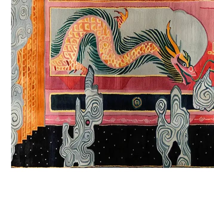 Vibrant hand-tufted wool area rug featuring an intricate dragon design in bright orange and green hues. The dragon is surrounded by abstract geometric patterns in black, grey, and pink tones, creating a striking visual impact. This detailed corner view highlights the artistry and texture of the rug, perfect for adding a bold statement to any room.