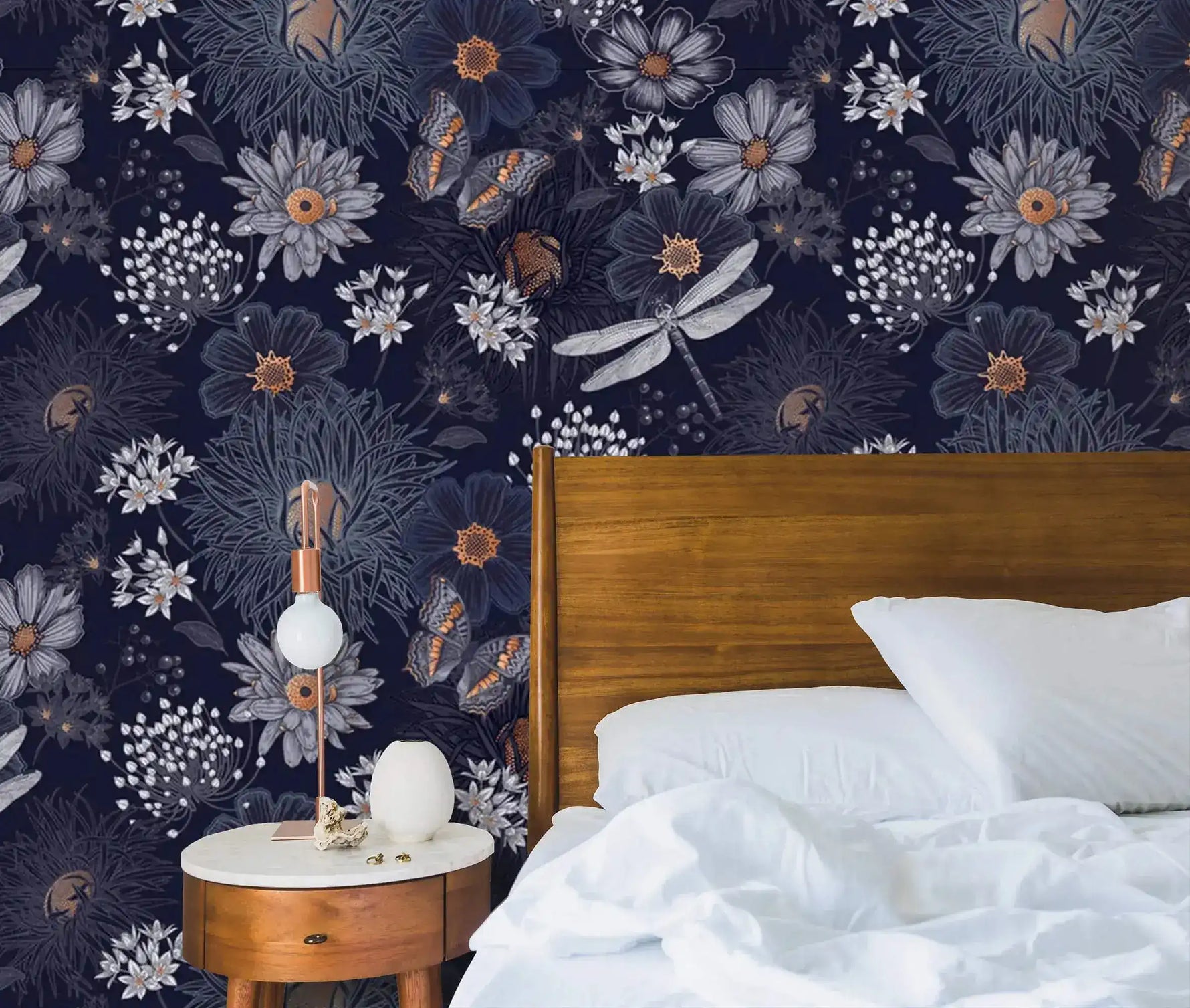 Dragonfly Ballet in Blossoms wallpaper as bedroom accent wall behind walnut bed, navy floral with dragonflies and butterflies