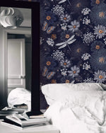 Dragonfly Ballet in Blossoms wallpaper as dark navy bedroom feature wall with dragonflies; white bed linens and mirror
