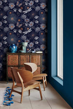 Dragonfly Ballet in Blossoms wallpaper on navy accent wall beside a blue window, antique sideboard and wooden chair setting
