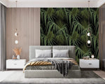 Green and black palm leaves wallpaper as headboard accent in modern bedroom with grey upholstered bed and white nightstands