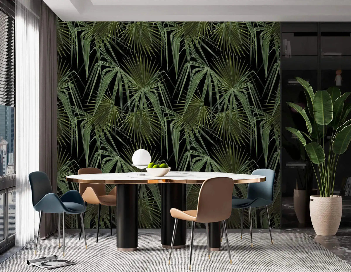 Green and black palm leaves wallpaper in dining room, full feature wall behind round table with blue and tan chairs