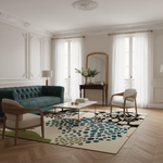 Living room with a green sofa, wooden chairs, and a patterned rug.