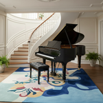 Black grand piano in a room with a colorful rug and staircase in the background