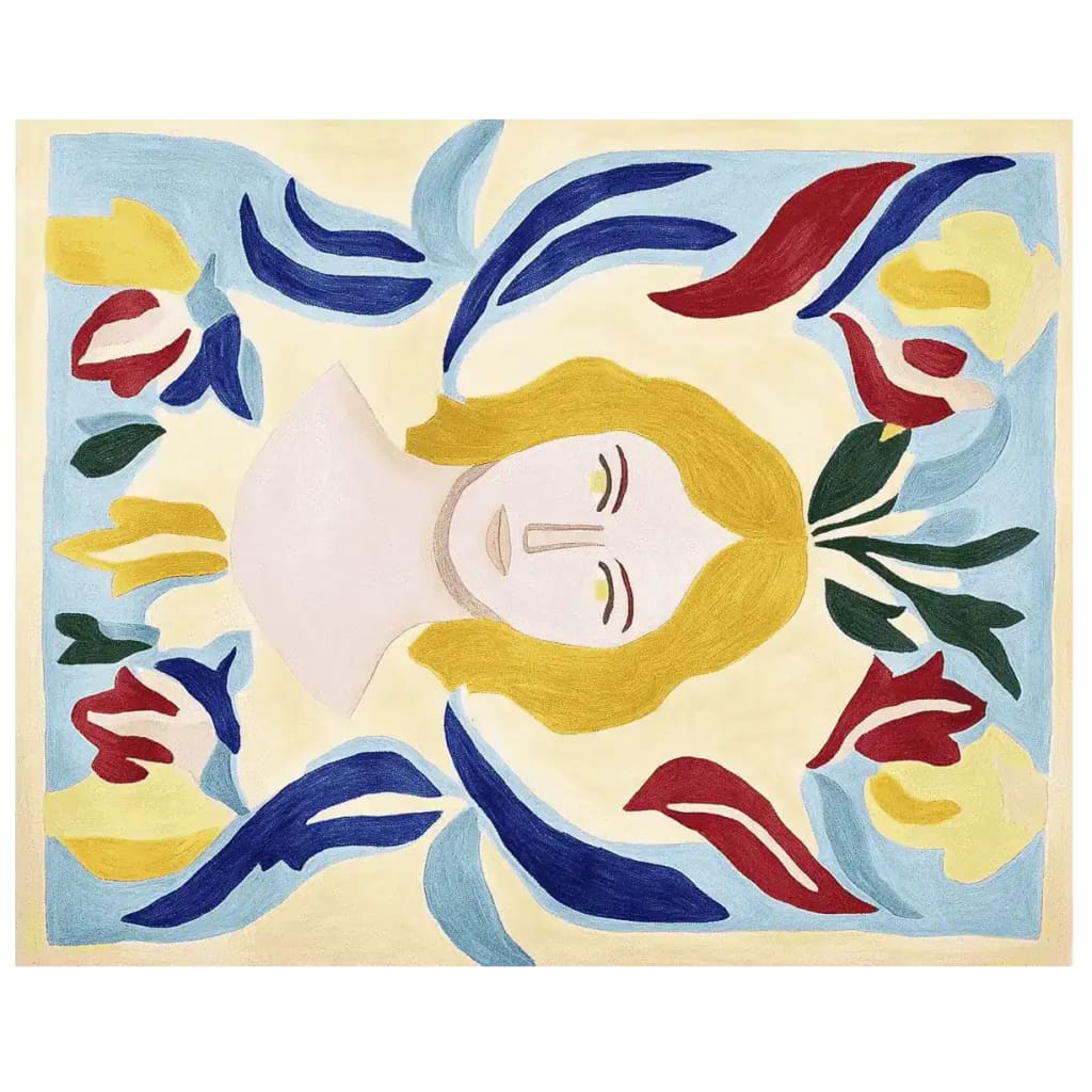 A vibrant, hand-tufted area rug featuring an abstract design with a central feminine face surrounded by colorful floral patterns. This contemporary wool rug adds a touch of artistic flair to any living room space.