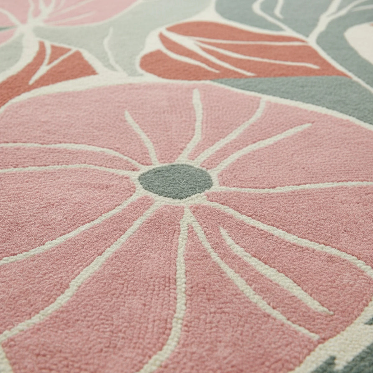 Close-up of a pink floral patterned rug with gray centers.