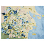 A vibrant and artistic area rug featuring an abstract design with swirling patterns of blue, green, and yellow. This contemporary wool rug adds a touch of elegance and creativity to any living room space.