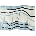 Top view of a contemporary area rug with an abstract design featuring flowing black lines on a soft white and blue background, ideal for large living rooms. This wool rug, titled 'Drifting Lines Hand Tufted Rug', brings a modern touch to any living room area.