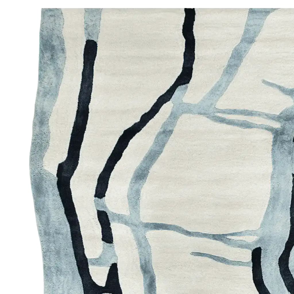 This is a detailed view of the Drifting Lines Hand Tufted Rug, a contemporary wool area rug. The abstract design features flowing lines in shades of blue and black against a neutral background. Perfect for large living rooms, this elegant rug adds a modern touch to any space, making it a stylish choice for living room area rugs.