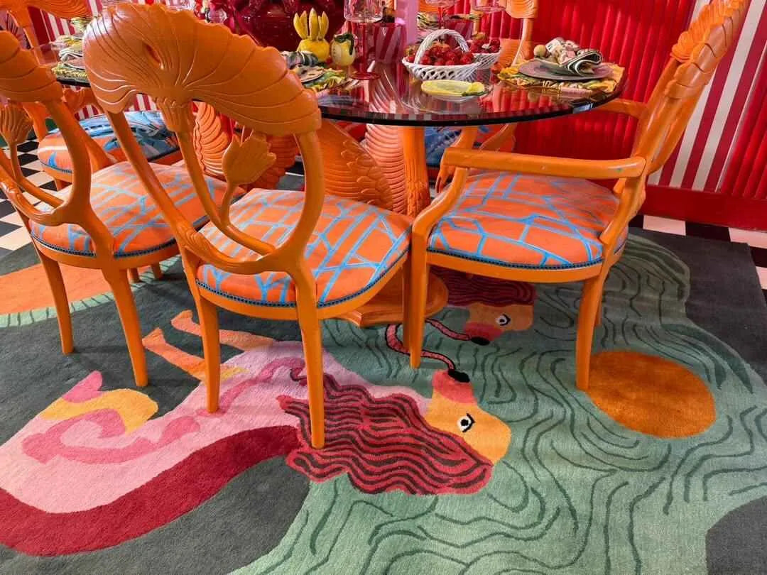 Contemporary Duo Tails Hand Tufted Area Rug in a vibrant dining room setting, featuring abstract lion motifs and colorful patterns, ideal for a stylish bedroom or office space.