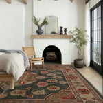 A cozy living room featuring a Dusk Blossom Hand Knotted Area Rug with intricate Persian-inspired patterns. The wool rug, in warm and earthy tones, complements the serene ambiance of the large space. Natural light floods through the windows, highlighting the rug’s detailed design.
