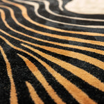 Close-up of a black and gold striped pattern rug