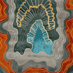 Top view of the Earth Rift Flow Hand Tufted Rug, an area rug perfect for a contemporary living room. The design features abstract waves in shades of blue, grey, and orange, resembling geological layers. This large living room rug is made of high-quality wool, offering a stylish and modern touch to any space.