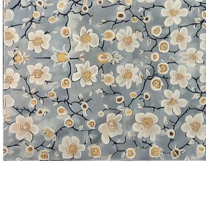 Elegant hand-tufted wool area rug featuring a serene floral design with delicate white and yellow blossoms on a soft blue background, perfect for adding a touch of eastern tranquility to any room.