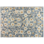 Top view of the Eastern Tranquility Hand Tufted Wool Area Rug, showcasing a serene floral pattern with delicate cream and beige blossoms on a soft blue background. This elegant area rug adds a touch of tranquility and style to any room.