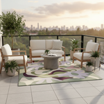 Outdoor patio with white furniture, a colorful rug, and potted plants with a cityscape in the background.