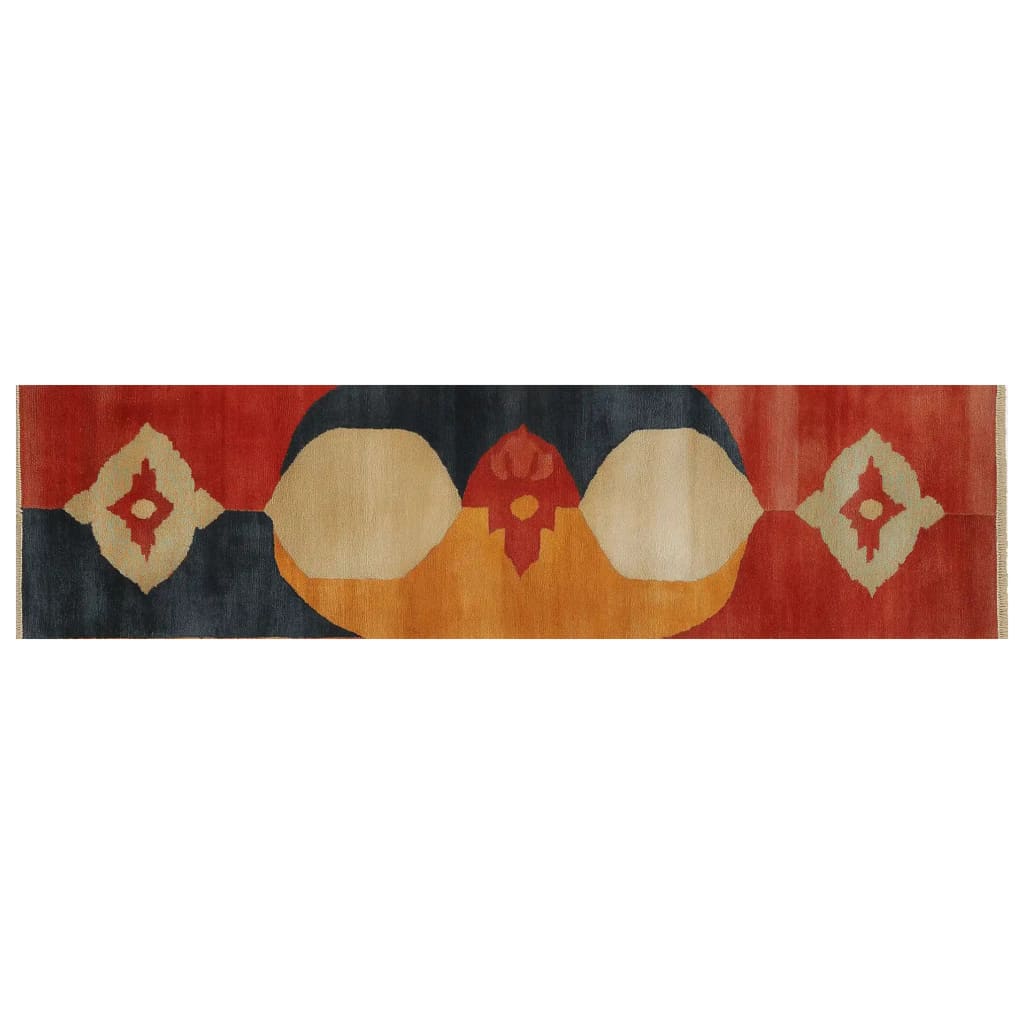 A striking area rug featuring an abstract design with vibrant colors including red, orange, and navy blue. The rug displays symmetrical patterns and bold geometric shapes, creating a dynamic visual appeal. This knotted wool rug is perfect for adding a touch of elegance and modern style to any room.