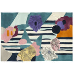 A vibrant Eclectic Bloom Hand Tufted Area Rug featuring colorful abstract floral patterns. This contemporary wool rug is perfect for adding a splash of color to large living room spaces, showcasing shades of purple, orange, pink, and blue against a striped background.