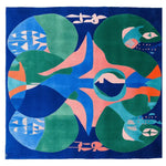Vibrant and contemporary square area rug featuring an eclectic abstract design with bold colors like blue, green, and orange, perfect for adding a modern touch to your living room. Hand-tufted from wool, this area rug combines artistic flair with cozy warmth, ideal for any stylish home decor.
