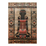 This image showcases the Egyptian Enigma Wool Hand Knotted Area Rug, featuring a striking design with an abstract figure seated in an intricate pattern. The rug's earthy tones blend harmoniously, emphasizing its detailed borders and cultural motifs, perfect for adding a touch of elegance and mystery to any room.