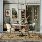 Elegant dining room featuring an Egyptian Mythology Hand Knotted Area Rug. The rug, with its intricate designs and warm colors, complements the sophisticated decor with a round dining table and stylish chairs. Classic wall art and cabinetry add to the room's inviting atmosphere.