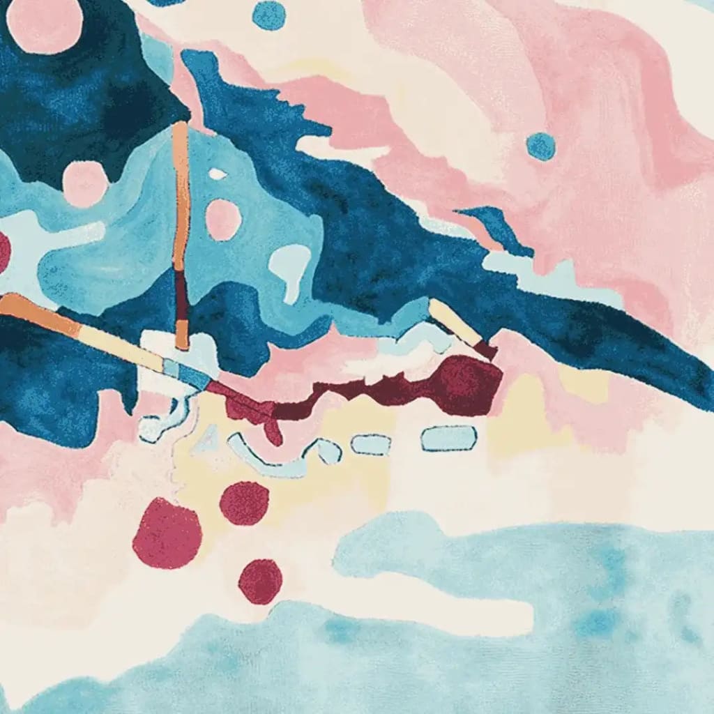 A vibrant hand-tufted wool area rug featuring an abstract design with bold splashes of blue, pink, and burgundy, ideal for contemporary living rooms.