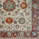Intricately designed Elegance in Bloom hand-knotted area rug featuring vibrant floral patterns with rich red and earthy tones. The detailed border and elegant motifs create a luxurious feel, perfect for adding sophistication to any room.