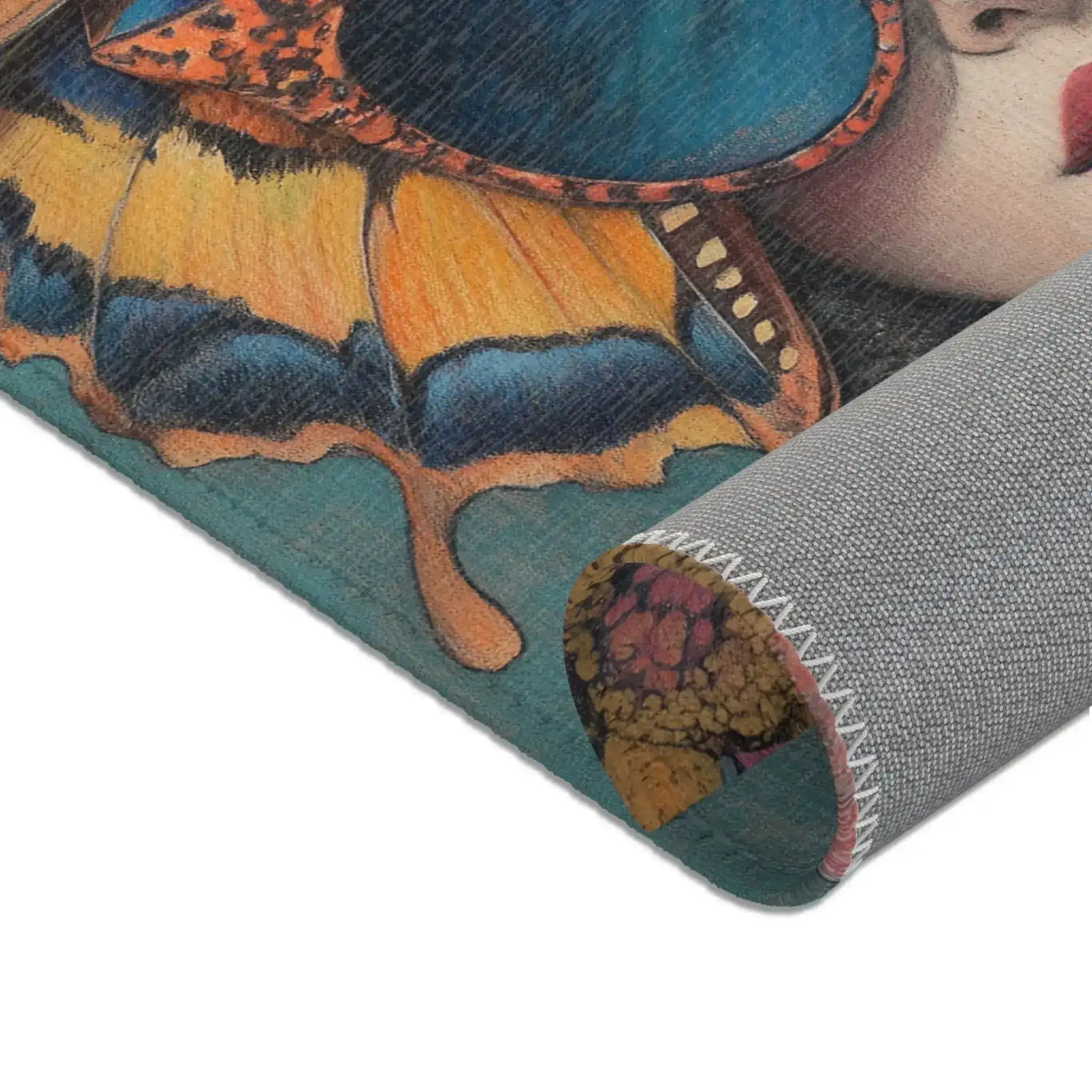 Macro rolled corner of Elegance in Flight Couture Butterfly Accent Rug revealing orange yellow butterfly wing teal face and grey backing