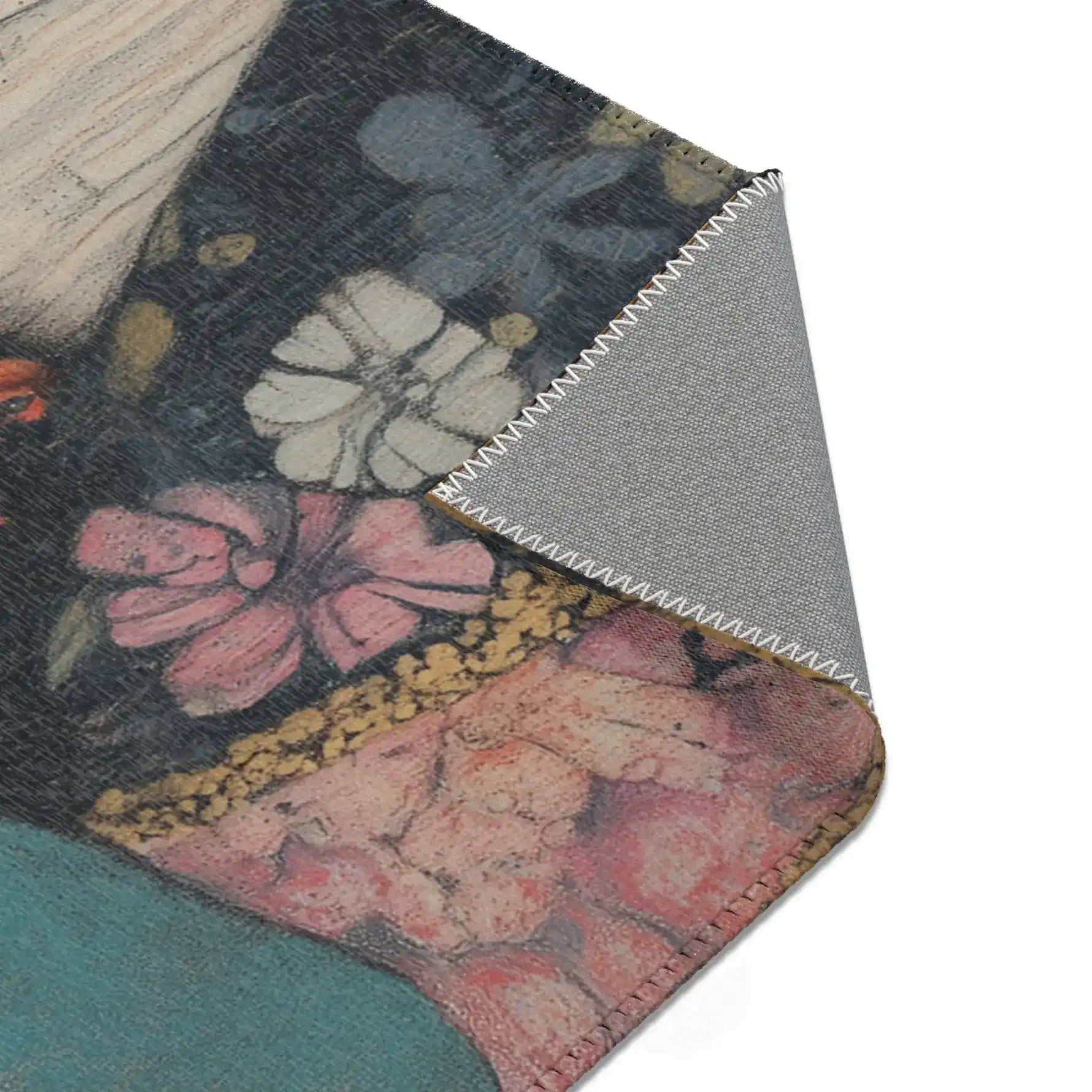 Corner fold of Elegance in Flight Couture Butterfly Accent Rug showing pink floral dark jacket print and grey non-slip backing edge