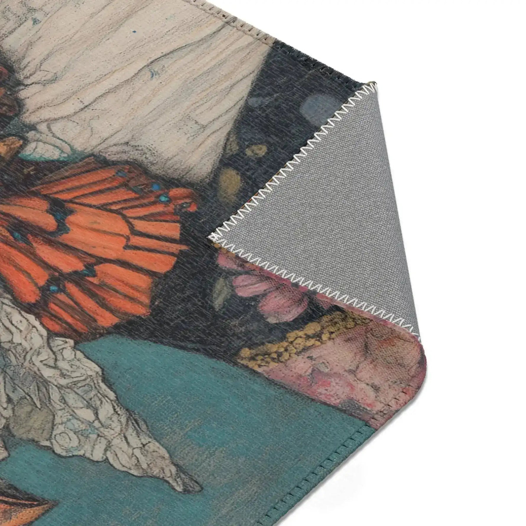 Corner fold of Elegance in Flight Couture Butterfly Accent Rug showing butterfly floral jacket print with grey anti-slip backing overlock stitch