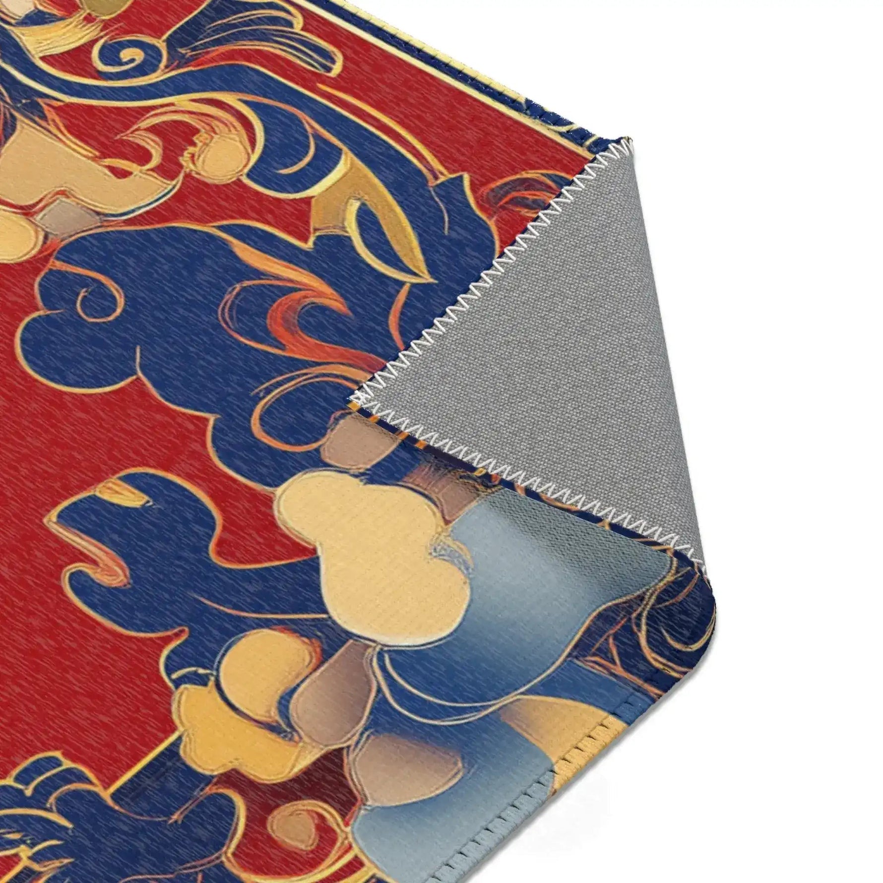 Corner fold of Elegant Chinoiserie Red & Blue Accent Rug showing warm-toned architectural pattern and gray backing
