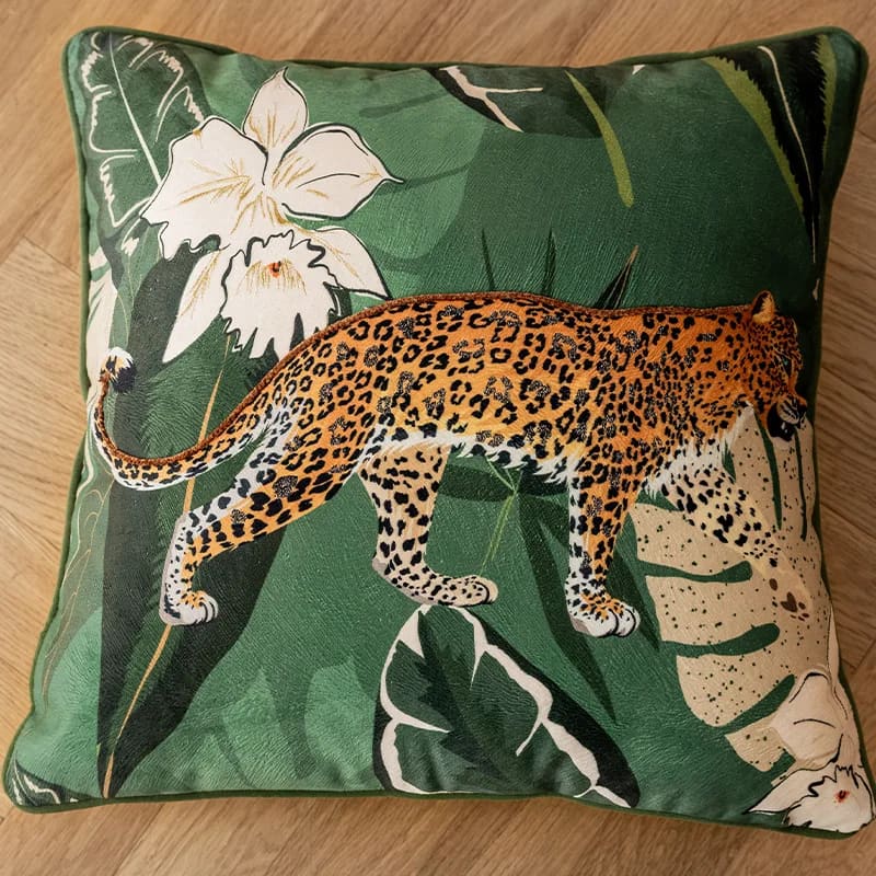 Elegant green leopard-print throw pillow cover featuring a detailed leopard design against a lush background of leaves and flowers.