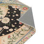 Elegant Woman and Floral Art Rug corner folded back showing grey non-slip backing with dark floral field and round white floral dot details