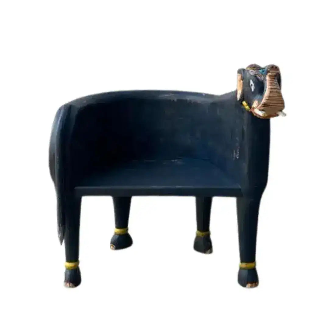 Hand crafted wooden elephant Maharaja chair in dark navy, left-front view showing barrel seat and decorated elephant head.