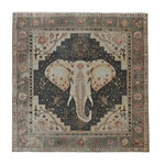 A stunning hand-tufted area rug featuring a detailed elephant design at the center, surrounded by intricate geometric and floral patterns. This large area rug, perfect for living rooms, showcases a blend of earthy tones, making it an elegant wool rug choice for enhancing any living space.