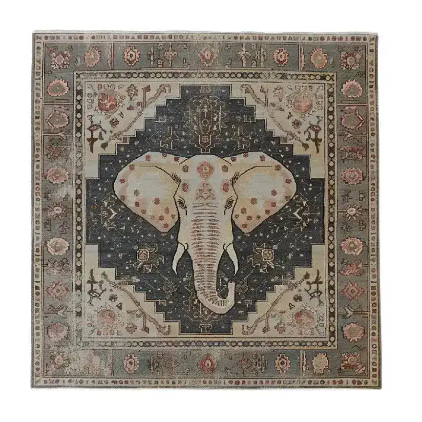 A stunning hand-tufted area rug featuring a detailed elephant design at the center, surrounded by intricate geometric and floral patterns. This large area rug, perfect for living rooms, showcases a blend of earthy tones, making it an elegant wool rug choice for enhancing any living space.