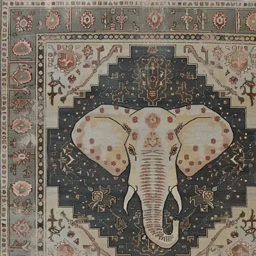 A beautifully detailed hand-tufted area rug featuring an intricate elephant design at the center. Perfect for adding a touch of elegance to your living room, this large wool rug combines traditional and modern motifs, making it an ideal choice for anyone looking to elevate their space with a unique large area rug.