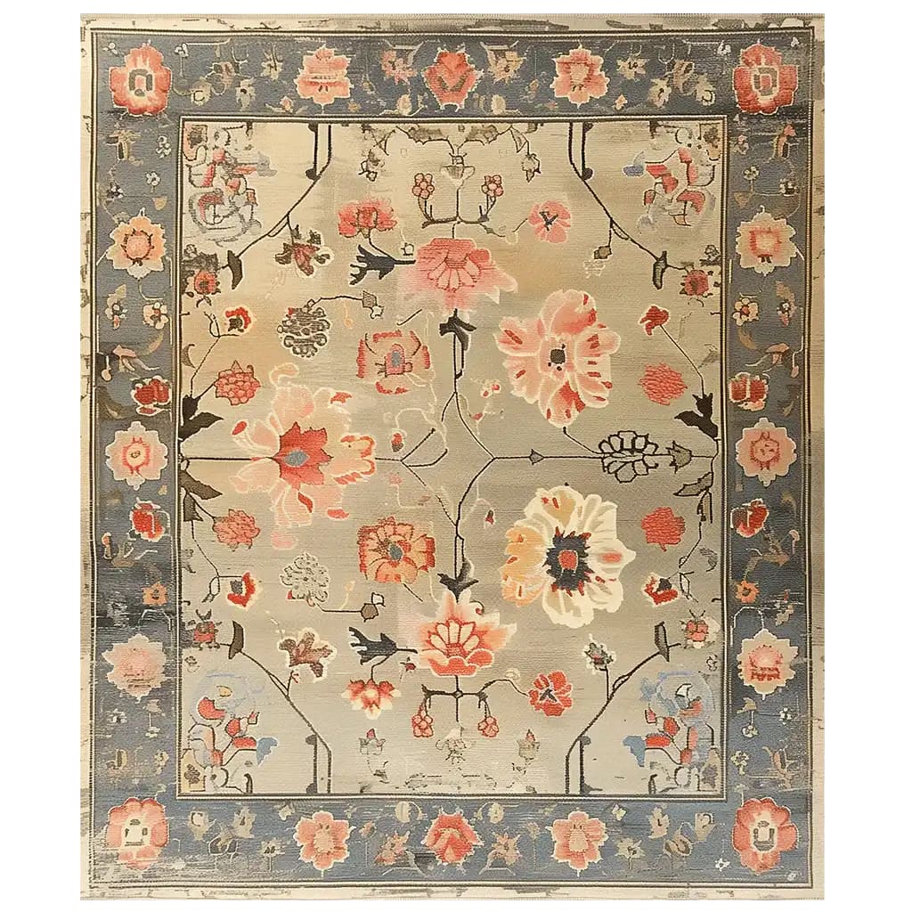 The Elysian Bloom Knotted Wool Area Rug features an intricate floral design with vibrant pink and orange flowers set against a muted beige background. The outer border showcases a contrasting deep blue tone with additional floral accents, adding a touch of elegance to any living space.