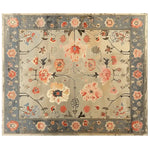 Top view of the Elysian Bloom Knotted Wool Area Rug featuring a sophisticated floral design in warm tones with a contrasting blue border, perfect for adding a touch of elegance to any living space.