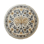 Round Elysian Palm Knotted Wool Area Rug featuring an intricate palm tree design with black and gold floral patterns on a cream background, showcasing detailed craftsmanship and a fringed edge.