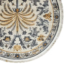 This elegant area rug showcases an intricate design with a central palm motif in golden hues, surrounded by detailed floral patterns in gray and gold on a light background. The round rug features a delicate fringe, adding a touch of sophistication to any room.