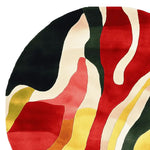 A vibrant round area rug featuring an abstract design with bold hues of red, green, yellow, and black. This contemporary wool rug adds a splash of color to large living room spaces, making it an ideal choice for those seeking unique rugs for their living room.