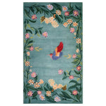 The Enchanted Floral Flight Knotted Wool Rug features a vibrant, hand-knotted design. A colorful hummingbird with red and blue wings is at the center, surrounded by a lush border of green leaves and multicolored flowers set against a soft blue background. This elegant area rug adds a touch of nature and whimsy to any space.
