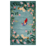 The Enchanted Floral Flight Knotted Wool Rug features a vibrant, hand-knotted design. A colorful hummingbird with red and blue wings is at the center, surrounded by a lush border of green leaves and multicolored flowers set against a soft blue background. This elegant area rug adds a touch of nature and whimsy to any space.