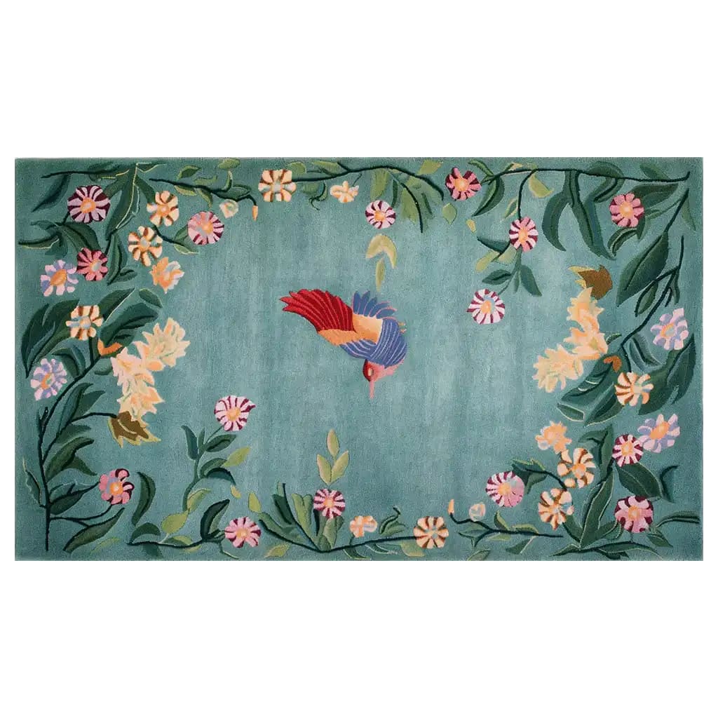 Vibrant area rug featuring a whimsical bird surrounded by colorful floral patterns on a soft blue-green background. The intricate design showcases a blend of nature-inspired elements in a knotted wool texture, perfect for adding a touch of enchantment to any room decor.